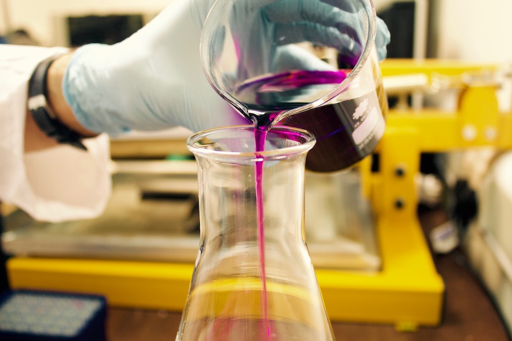 Liquid pouring into beaker in laboratory